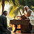 Poetry: The first image is a garden of palms where light drips like oil from fronds.  Two men bend over a...